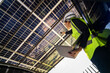 © ultramansk - Engineer in safety vest and helmet pointing towards a solar powered carport, illustrating eco-friendly innovation in parking infrastructure. Solar panels provide shade and sustainable energy.