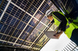 © ultramansk - Engineer in safety vest and helmet pointing towards a solar powered carport, illustrating eco-friendly innovation in parking infrastructure. Solar panels provide shade and sustainable energy.
