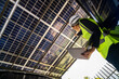 © ultramansk - Engineer in safety vest and helmet pointing towards a solar powered carport, illustrating eco-friendly innovation in parking infrastructure. Solar panels provide shade and sustainable energy.