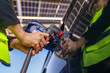 © ultramansk - Engineer in safety vest and helmet pointing towards a solar powered carport, illustrating eco-friendly innovation in parking infrastructure. Solar panels provide shade and sustainable energy.
