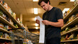 © InfinityVisuals - Grocery List Dilemma: A concerned shopper scrutinizes a lengthy grocery list in a brightly lit supermarket aisle, a trolley beside him.