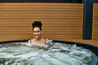 © Bliss - Young woman enjoying a blissful soak in a tranquil spa environment for ultimate relaxation