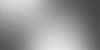 © alongkorn89 - Sleek silver metallic background with a fine grainy texture and smooth gradient light reflections.