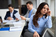 © Goran - Displeased female entrepreneur having a meeting in the office. Her colleagues are in the background