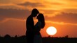 © mila103 - Couple embracing in sunset silhouette on open field horizon