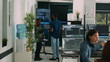 © DC Studio - Diverse team of system developers analyzing code on big tv screen, checking errors in artificial intelligence project. Programmers working on machine learning software, developing new interface.