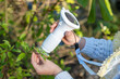 © kittyfly - girl Child holding digital microscope, examining texture on LCD screen, educational science toy, young explorer using child-friendly camera to capture beauty nature, blending play outdoor education