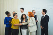 © Singh - diverse group multi-generational business professional smile shak hand front white board during successful meeting representing global teamwork inclusive corporate culture partnership