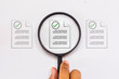 © niwat - The magnifying glass focuses on the document. Document management, file searching and verification.