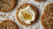 © AkuAku - Overhead view of gourmet gluten free seed crispbread topped with creamy cheese spread