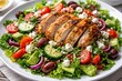 © vxnaghiyev - Close up of a rotisserie chicken salad with feta cheese and fresh vegetables on a white plate