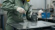 © Bakha - Worker applying protective paint on metal surface wearing gloves in industrial workshop