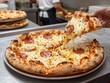 © adidesigner23 - Hand lifting a slice of fresh pepperoni pizza with melted cheese in a pizzeria kitchen