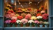 © Vadym - Colorful flowers fill a shop window. Roses tulips lilies and more are arranged beautifully for sale. Customers can choose bouquets for any occasion.