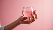 © Vadym - Woman hand with pink manicure holds glass of pink beverage on pink background. She enjoys a refreshing drink in style. Clean modern aesthetic.