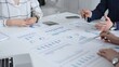 © volha_r - Business people reading contracts and documents while holding mobile phones during a corporate meeting, preparing to sign an agreement at a white office table indoors