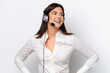 © luismolinero - Telemarketer caucasian woman working with a headset isolated on white background posing with arms at hip and smiling
