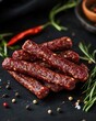 © Espresso - A pile of savory, spicy sausage sticks surrounded by herbs and spices, creating a rich, appetizing display.
