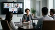 © Justlight - Hybrid meeting highlights a key manager discussing plan design tweaks via video call with participants visible but softly out of focus on screens behind.