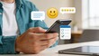 © Emma - Man holding smartphone with floating icons of five star rating smiley face chat bubble and checklist symbolizing customer satisfaction positive feedback survey and mobile app