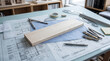 © Isa - Wooden plank and drafting tools on architectural blueprints for construction planning