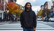 © Top - Man in Black Hoodie Standing on a Crosswalk in Autumn City Street with Colorful Trees and Cars