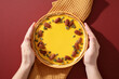 © ADDICTIVE STOCK - Hands holding pumpkin pie with pecan and seed topping