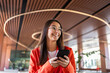 © ADDICTIVE STOCK - Woman in orange enjoying business success