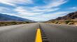 © thenort - A long, straight asphalt road disappears into the horizon, flanked by mountains and sky