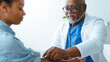 © Prostock-studio - A doctor examines a patient in a clinic. The doctor listens to the patient's heartbeat while measuring blood pressure. Both individuals appear focused and engaged in the process of an examination.