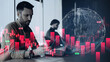 © Prostock-studio - Two professionals work in an office. One focuses on a tablet while analyzing digital charts showing market trends and stock data. The setting has modern decor and a digital globe displayed.