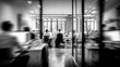 © Armin - A black and white photograph captures a bustling office environment with blurred figures and a focus on a group of individuals working at their desks.