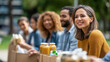 © Laura - Faceless diverse group of friends and volunteers outdoors discussing donations, charity, food aid, and poverty relief in a community outreach and NGO teamwork concept. Defocused