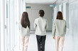© buritora - Female staff members from manufacturing, construction, transportation, and building industries, dressed in work clothes, walking down the corridor of an office building.