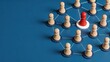 © Brooklyn - Red pawn leading wooden chess pieces on blue background business leadership concept strategic management team hierarchy corporate structure decision making authority success