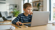 © NORN - Young Boy Engaged in Learning: A young boy engrossed in his studies, expertly navigating the virtual world, showcasing his dedication to learning.