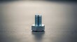 © Wool World - A shiny metal bolt stands alone on a dark gray surface indoors.