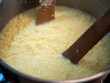 © Marek - Cooking traditional Easter egg cheese (hrudka) in a pot, curdling eggs mixture close to completion, close-up food preparation.