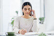 © peopleimages.com - Writing, woman and notebook with phone call in office for article lead, story investigation or verify info. Journalist, person or mobile chat with notes for news contact, online interview or feedback