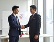 © Zain - Two men in business attire shaking hands in an office