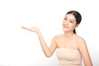 © kitthanes  - A beautiful young Asian woman with clean, fresh skin against a white background. Skincare, facial treatment, cosmetology, beauty, and spa. An elegant portrait of an Asian woman.