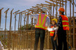 © Panumas - Structural engineer, architect and foreman worker with blueprints discuss, plan working for the outdoors building construction site. Construction collaboration concept