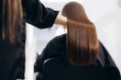 © Roman - Professional hairstylist doing keratin treatment on woman's hair