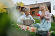 © Halfpoint - Senior grandmother with small granddaughter gardening during spring season.