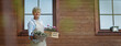 © Halfpoint - Senior woman gardening in spring, holding flowering plants.