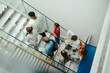© Halfpoint - Group of university students walking up stairs, back to school concept.