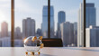 © babu - Glass piggy bank with gold details on office desk against cityscape