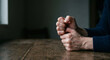 © MirofuruDesign - Closeup of anxious hands clasped on wooden table representing stress worry anxiety mental health challenges and emotional tension