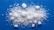© Taha - Pile of white crystals and granules on a blue surface