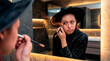 © Rendara Studio - Spellbound woman applying witch makeup in modern bathroom mirror